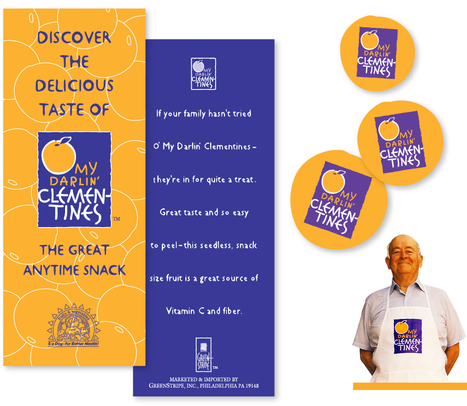 O' My Darlin Clementines Material, purple and orange brochures, cards, stickers and apron on grocer