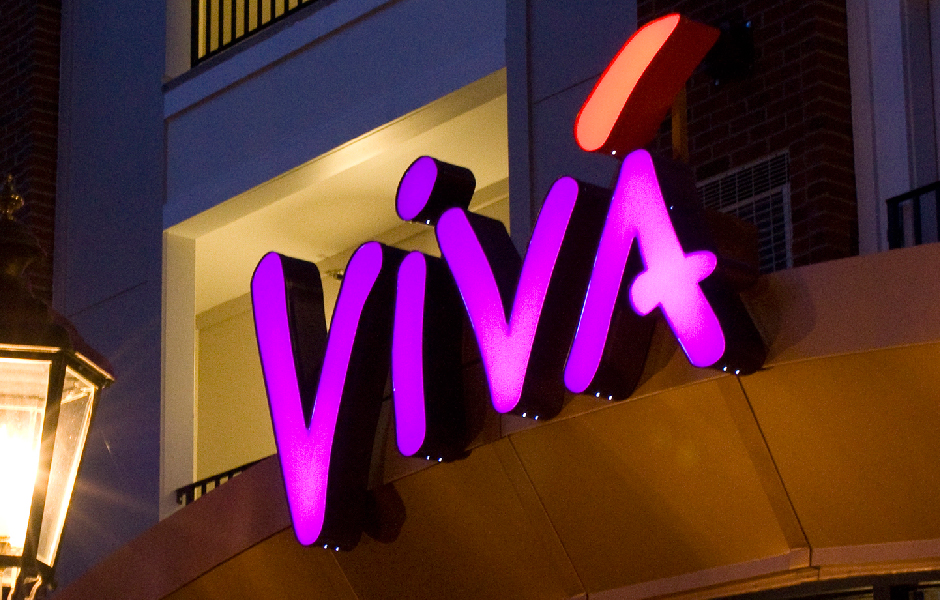 Vivá, Building Signage, Lit at Night with Lamp Shining